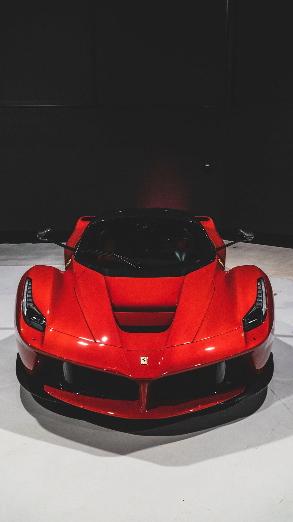 A sculpted sports car in low light